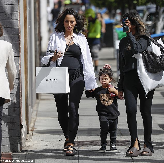Hailey Bieber flaunts baby bump in black romper on shopping spree